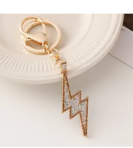 Detailed close-up of golden lightning bolt keychain with sparkling crystal rhinestones
