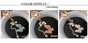 Detail view of crystal butterfly keychains in orange green and pink color options