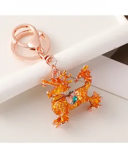 Detailed close-up of rose gold Kirin keychain with orange enamel and colorful rhinestones
