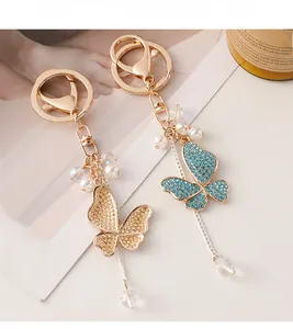 Detailed close-up of rhinestone butterfly keychain with elegant tassels and pearls