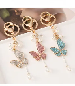 Macro shot of three crystal butterfly keychains with rhinestones and elegant tassels