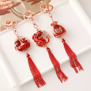Chinese style festive tassel keychains with red enamel fish and fortune bag pendants