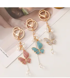 Detailed macro view of butterfly keychains with sparkling crystals and elegant tassels