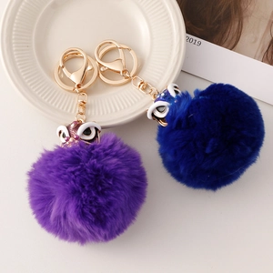 Porte-clés lion chinois avec pompon en peluche et fermoir doré en bleu et violet
