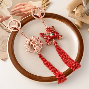 Traditional Chinese style keychain with red tassels and golden auspicious beast pendant