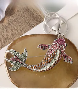 Détail du porte-clés broche poisson avec strass roses et orange sur métal argenté