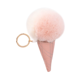 Pink and white faux fur ice cream cone keychain with gold metal ring on white background