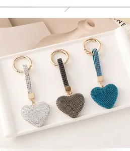 Detailed view of silver, black and blue heart keychains with sparkling rhinestones