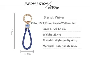 Detailed view of blue braided leather keychain with golden ring and wealth charm