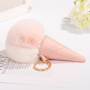 Pink and white fluffy ice cream cone keychain with gold ring on aesthetic background