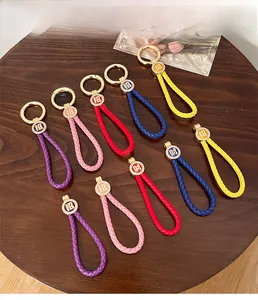 Detail of woven PU leather keychains with rhinestones and lucky Chinese charms