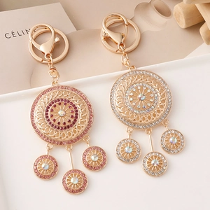 Fashion dreamcatcher mandala keychain with rhinestones on a white ceramic plate