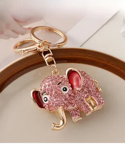 Close-up of golden elephant keychain with pink rhinestones and red enamel details