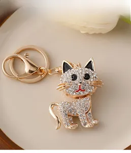 Detailed close-up of a sparkling rhinestone-studded cat keychain in gold plating