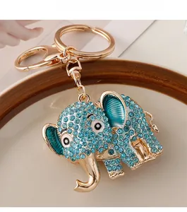 Detailed macro view of gold-tone elephant keychain with sparkling blue rhinestones