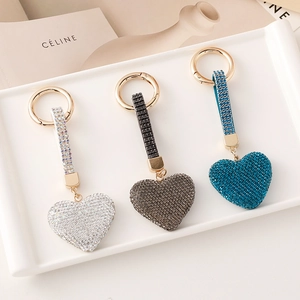 Three elegant heart-shaped rhinestone keychains in silver, grey and blue with gold rings