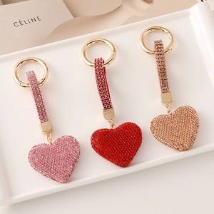 Three premium heart-shaped keychains with pink, red, and gold crystals for women bags