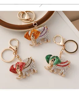 Three variants of diamond elephant keychains with enamel detailing and metal clips