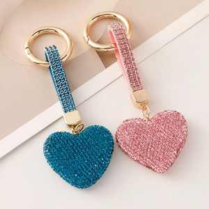 Sparkling crystal heart keychains in blue and pink with gold plating and full rhinestone pave