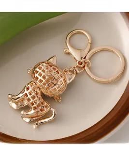 Detailed close-up of a golden hollow mesh cat keychain featuring a lobster clasp and ring