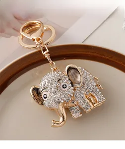 Close-up of sparkling crystal encrusted golden elephant charm with lobster clasp detail