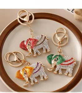 Detailed view of three colorful crystal elephant keychains with enamel patterns on a plate