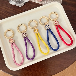 Colorful woven leather keychains with gold rhinestones and Lucky character motifs