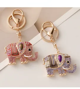 Close-up of pink and purple crystal elephant keychains with gold plating and rhinestones