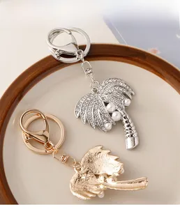 Detail of coconut tree keychain showing gold and silver finishes with rhinestones