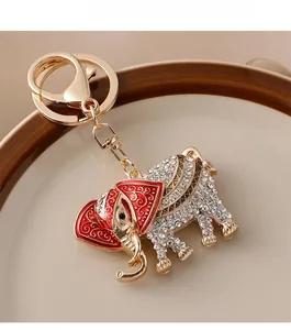 Close-up of golden elephant keychain with sparkling rhinestones and red enamel detail