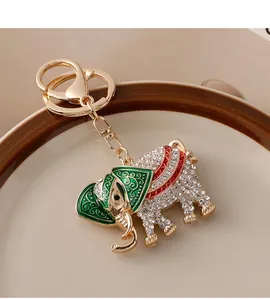 Detailed macro view of Thai elephant keychain with gold metal plating and white rhinestones