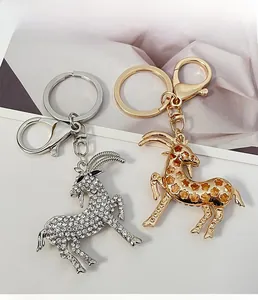 Detailed view of goat-shaped alloy keychains in silver and gold with sparkling crystals