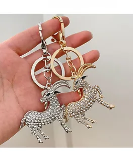 Detailed view of goat keychains with sparkling rhinestones in gold and silver tones