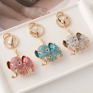 Cartoon elephant keychains with colorful rhinestones in pink, blue, and white colors