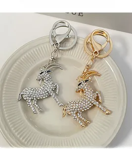 Close-up of goat animal keychains featuring sparkling rhinestones in gold and silver