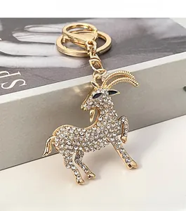 Detailed view of goat keychain with sparkling white crystals and gold alloy finish