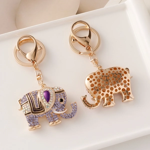 Golden elephant keychain with purple rhinestones and hollow honeycomb back structure