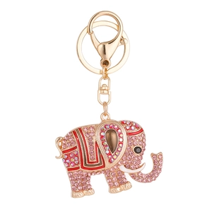Golden elephant keychain with pink rhinestones and colorful enamel on white background