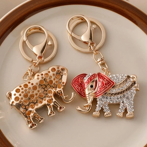 Golden elephant keychain with white rhinestones and red enamel, front and back view