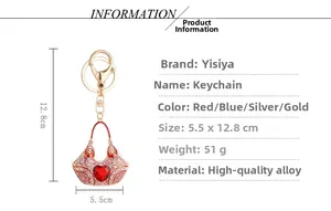 Macro detail of handbag heart keychain with red crystals and golden alloy finish