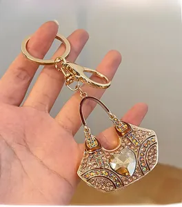 Detail of a sparkling rhinestone handbag keychain with a large heart crystal held in hand