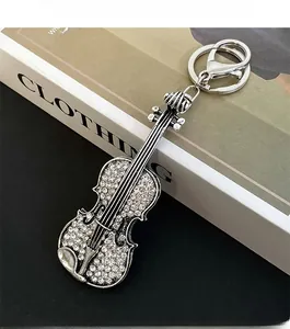 Detailed macro view of violin keychain featuring silver metal and sparkling rhinestones