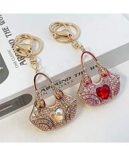 Detail of luxury rhinestone handbag keychains with heart crystals on vintage book