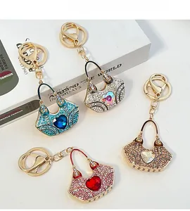 Detailed view of crystal handbag keychains in four colors with heart-shaped gems