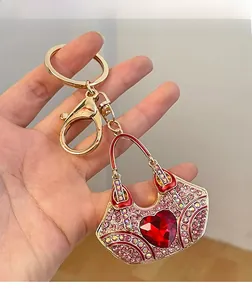 Macro shot of handbag keychain featuring pink rhinestones and a red heart crystal