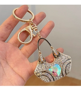 Macro detail of handbag keychain with crystal rhinestones and AB heart stone charm