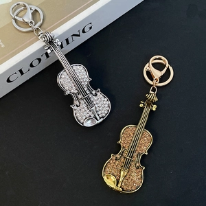 Fashionable violin keychain set with sparkling crystals in silver and gold metal finishes