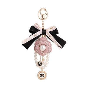 Porte-clés élégant avec camélia, perles, fleur en tissu rose et nœud en ruban pour sac