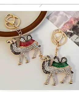 Close-up of golden camel keychain with sparkling rhinestones and enamel saddle detail