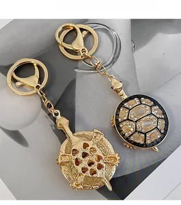 Détail du porte-clés tortue montrant la coque en strass et le dos en métal évidé